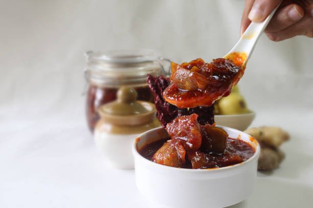 Traditional Indian Lemon pickle or Nimbu ka Aachar.sweet and sour lemon pickle with jaggery and ginger.