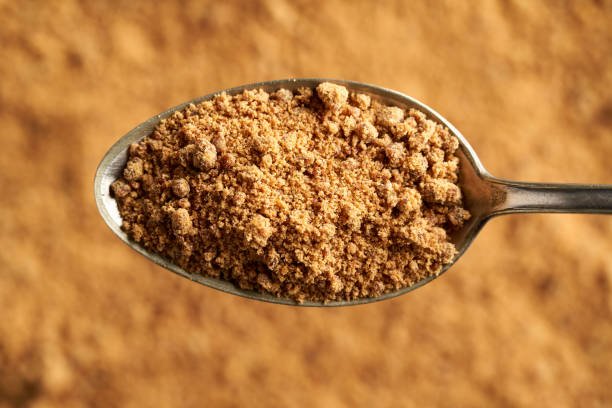 Panela or rapadura - healthy sweetener made by evaporating sugercane juice, on a spoon