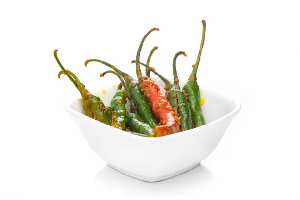 Close-up of Indian Organic pickle (Achar) made from Indian Green Chillies ( hari mirch ). Very spicy, tart, acetic in taste and aromatic. A mixture of ayurvedic spices and herbs with vegetables in edible oil (specially mustard).