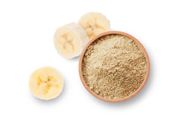 Banana flour (banana protein powder) in wooden bowl with fresh fruit isolated  background. Top view. Flat lay.