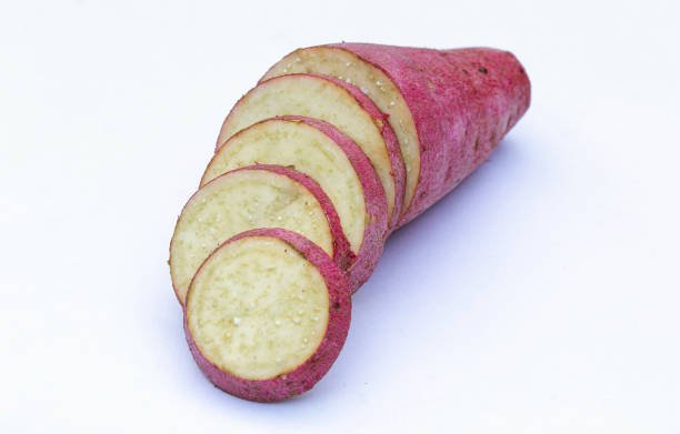 Sliced of sweet potatoes on white background close-up view